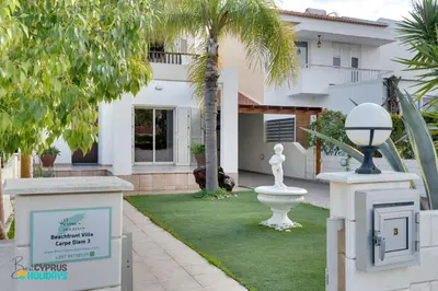 a house with a garden with a statue in the yard at Beachfront Villa Carpe Diem in Mor Menekshe