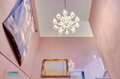 a chandelier in a hallway with a mirror at Beachfront Villa Carpe Diem in Mor Menekshe