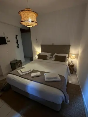 a bedroom with a large bed with two towels on it at GaliniCafe22-suites in Kakopetria