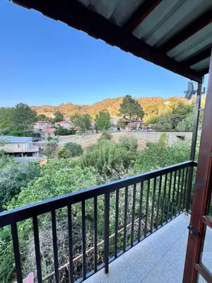a balcony with a view of a mountain at GaliniCafe22-suites in Kakopetria