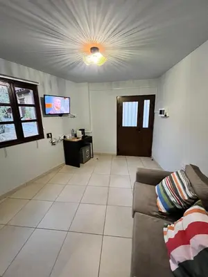 a living room with a couch and a flat screen tv at GaliniCafe22-suites in Kakopetria