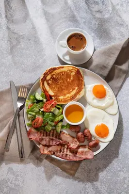 a plate of breakfast food with eggs and a cup of coffee at Urban Condo 43 - 1 Bdr in Nicosia