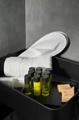 a box with four bottles of essential oils and a towel at Urban Condo 43 - 1 Bdr in Nicosia