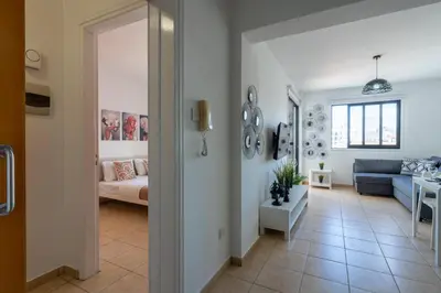 a living room with a couch and a table at Polyn 1- Bedroom Apartment in Larnaca in Larnaka