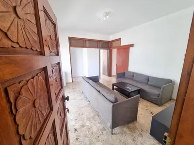 a living room with a couch and a table at Luxury City Rooms - Smart TV with Netflix in Larnaka