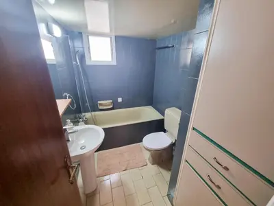 a bathroom with a white toilet and a sink at Luxury City Rooms - Smart TV with Netflix in Larnaka