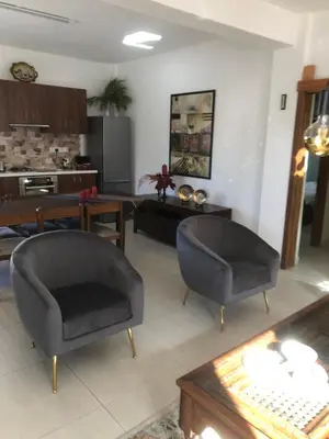 a living room with two chairs and a table at DIAMOND Stone Wooden Guest House in Khandria