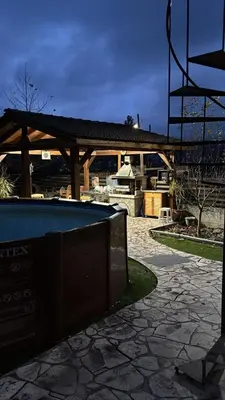 a backyard with a swimming pool and a pavilion at DIAMOND Stone Wooden Guest House in Khandria
