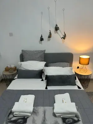 a bedroom with a large bed with towels on it at HESTIA Studio Downtown Nicosia in Nicosia