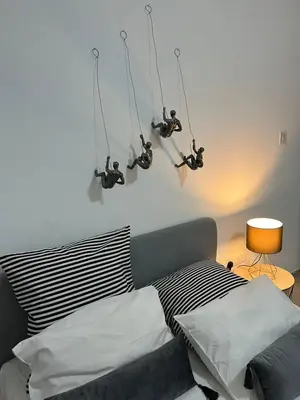 a bedroom with a bed with three lights above it at HESTIA Studio Downtown Nicosia in Nicosia