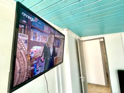 a flat screen tv hanging on a wall at Nemesis Second floor studio in downtown Nicosia in Nicosia