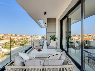 a balcony with two couches and a table with a view at Sanders Elgio in Limassol
