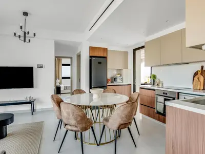 a kitchen with a round table and chairs at Sanders Elgio in Limassol
