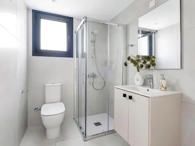 a bathroom with a shower and a toilet and a sink at Sanders Elgio in Limassol