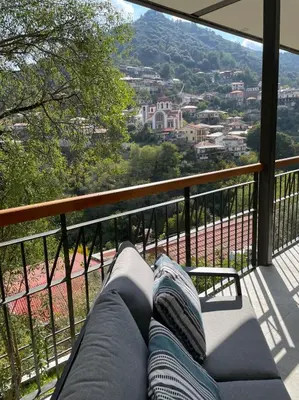a couch on a balcony with a view of a city at Balkoni Moutoullas in Moutoullas