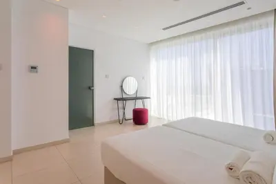 a white bedroom with a bed and a window at Cove Seaview Villas - Nautica in Ayia Napa