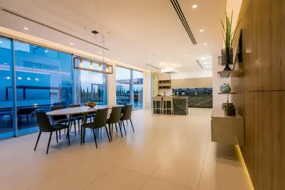 a dining room and kitchen with a table and chairs at Cove Seaview Villas - Nautica in Ayia Napa