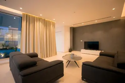 a living room with two couches and a flat screen tv at Cove Seaview Villas - Nautica in Ayia Napa