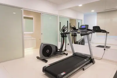 a gym with a treadmill and a elliptical machine at Cove Seaview Villas - Neptune in Ayia Napa