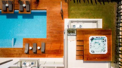 a building with a pool and a clock on it at Cove Seaview Villas - Neptune in Ayia Napa