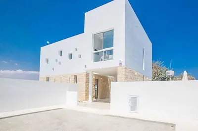 a house with white walls and a blue sky at Vie Blue 4 in Protaras