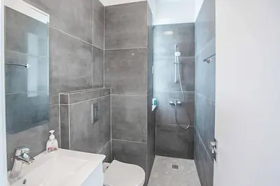 a bathroom with a shower and a toilet and a sink at Vie Blue 4 in Protaras