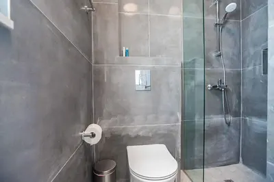 a bathroom with a toilet and a glass shower at Vie Blue 4 in Protaras