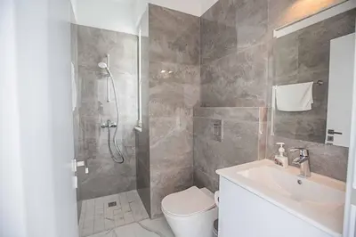 a bathroom with a shower and a toilet and a sink at Vie Bleu 1 in Protaras