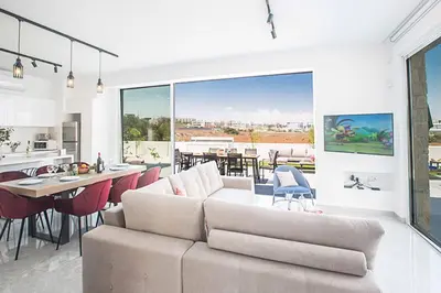 a living room with a couch and a dining room at Vie Bleu 3 in Protaras