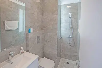 a bathroom with a shower and a toilet and a sink at Vie Bleu 3 in Protaras