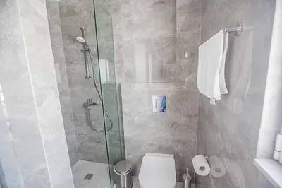 a bathroom with a toilet and a glass shower at Vie Bleu 3 in Protaras