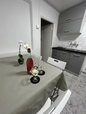 a table with wine glasses and a vase with flowers on it at Avra House in Limassol