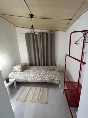 a bedroom with a bed and a curtain at Avra House in Limassol