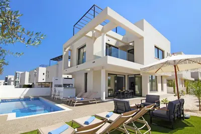 a villa with a swimming pool in front of it at Queen Lydia in Protaras