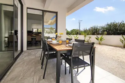 a dining room with a table and chairs at Queen Lydia in Protaras