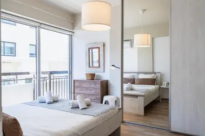 a bedroom with a bed and a balcony at Berries 1-BR Apt in Larnaca in Larnaka