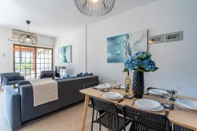 a living room with a table and a couch at Azure 2-BR W/Terrace in Larnaca in Larnaka