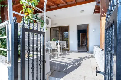 an open gate to a patio with a table and chairs at Azure 2-BR W/Terrace in Larnaca in Larnaka