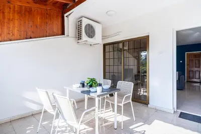 a dining room with a table and chairs at Azure 2-BR W/Terrace in Larnaca in Larnaka