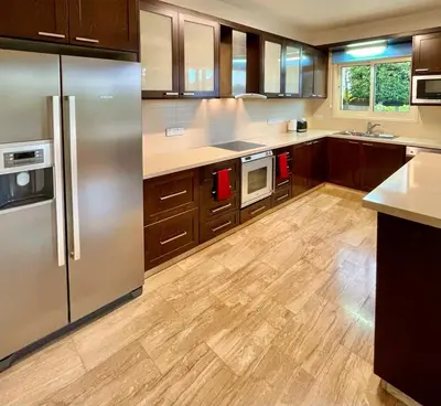a kitchen with wooden floors and stainless steel appliances at El Soleo Luxury Villa in Limassol