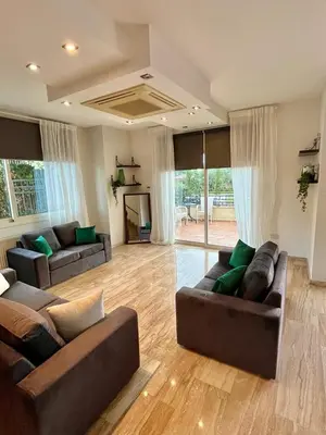 a living room with two couches and a television at El Soleo Luxury Villa in Limassol