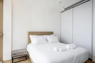 a bedroom with a white bed with two towels on it at 360 Nicosia - 2 bedrooms Luxury Residence in Nicosia