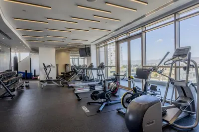 a gym with cardio equipment in a building with windows at 360 Nicosia - 2 bedrooms Luxury Residence in Nicosia