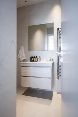 a white bathroom with a sink and a mirror at 360 Nicosia - 2 bedrooms Luxury Residence in Nicosia