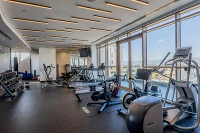 a gym with cardio equipment in a building with windows at 360 Nicosia - 2 bedrooms Luxury Residence in Nicosia