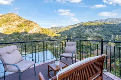 a balcony with chairs and a view of a mountain at House Eufrosyne in Moutoullas