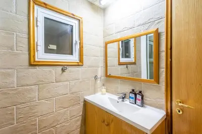 a bathroom with a sink and a mirror at House Eufrosyne in Moutoullas