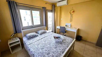 a bedroom with a bed and a desk and a window at Comfy and Exquisite ROOMS in a Shared 3BR Apartment Near Main Harbor, City Center in Larnaka