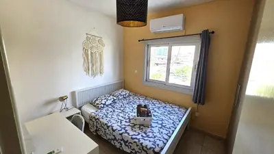 a small bedroom with a bed and a window at Comfy and Exquisite ROOMS in a Shared 3BR Apartment Near Main Harbor, City Center in Larnaka
