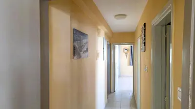 a hallway with yellow walls and a tile floor at Comfy and Exquisite ROOMS in a Shared 3BR Apartment Near Main Harbor, City Center in Larnaka